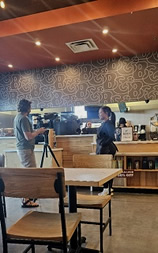 Filmmaker David White with Store manager Ashley at Beans & Brews in Springville Utah.