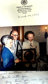 Phillip B Gottfredson honors Governor Scott Matheson and Norma Matheson for supporting the arts, giving them one of his handcrafted picture frames. 